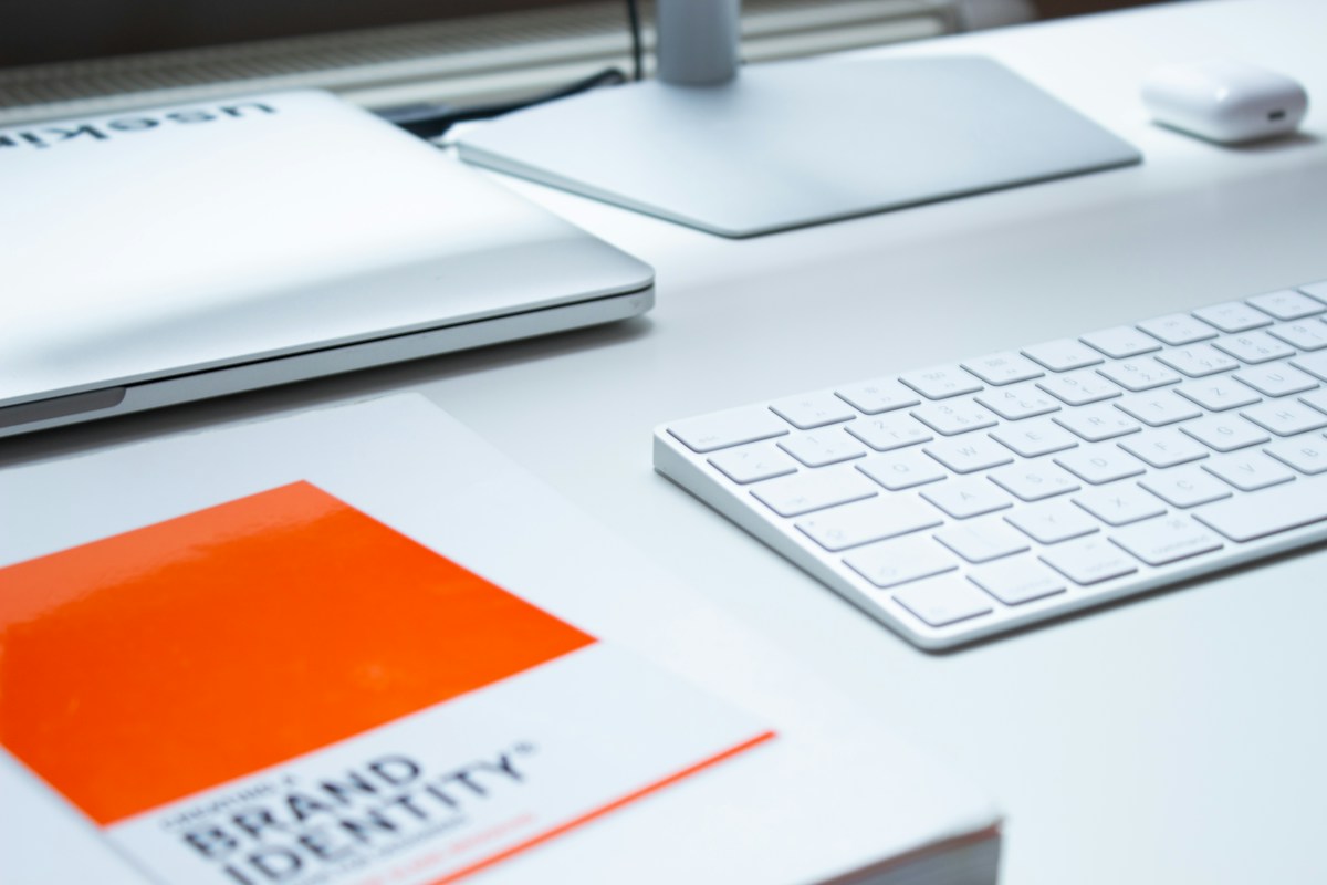 A laptop and keyboard on a clean workspace